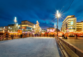 Fototapeta na wymiar Traditional street market and ice skating rink at Christmas time