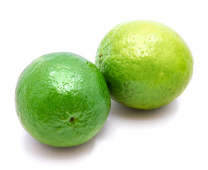Two whole green limes isolated on white background.