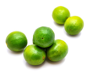 Group of whole green lime isolated on white background.