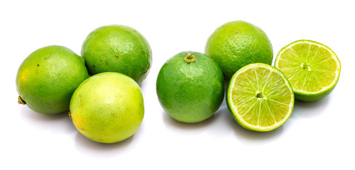 Group of whole and lime halves isolated on white studio background.