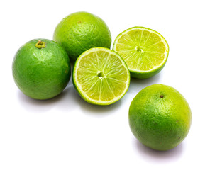 Group of whole limes and sliced halves isolated on white studio background.