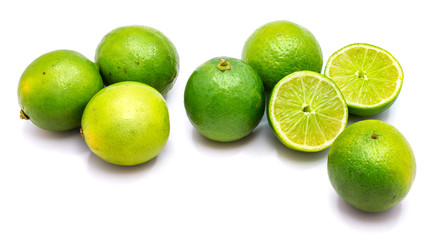 Group of whole and lime halves isolated on white studio background.