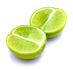Two lime halves, sliced, isolated on white studio background.