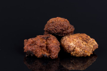 Meatballs isolated above black background with reflections and copy space