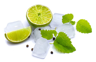 One half and lime slice, lemon balm leaves, pure ice cubes and pepper isolated on white studio background.