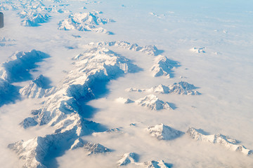 Fototapeta na wymiar aerial view of snowy alps range, during winter season