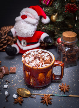 hot cocoa with marshmallow in a brown ceramic mug