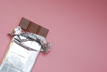 Chocolate on a Foil on a Pink Background in Corner Isolated - Powered by Adobe