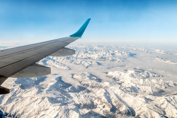 Obraz na płótnie Canvas aerial view of snowy alps range, during winter season