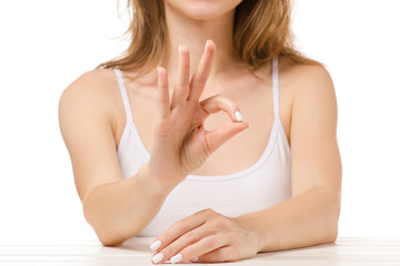 Beautiful woman sitting sign okay
