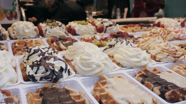 Waffles with strawberry and cream in shop, different waffles in brussels cafe