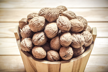 Walnuts in a wooden bucket.