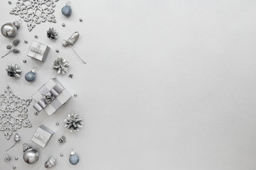 Monochrome Holiday pattern with gift boxes and New Year decoration, snowflakes on silver...