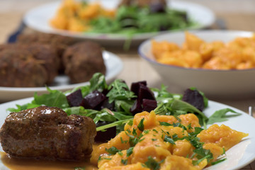 Healthy dish - roast beef roulade, carrot dumplings and rucola salad with red beetroot