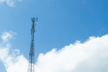 Obraz premium Mobile phone transmitter pole on blue sky and clouds