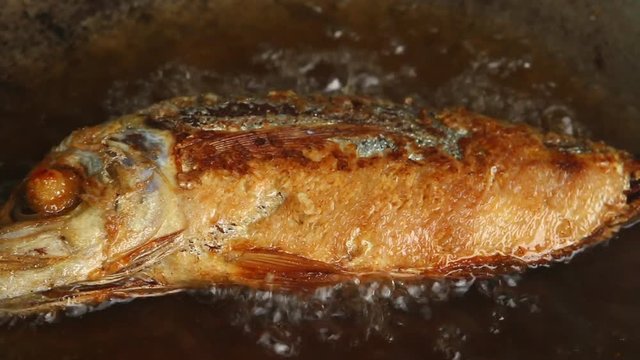 frying mackerel fish in pan