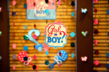 A Girl or Boy tag hanging in a gender revealing party decoration
