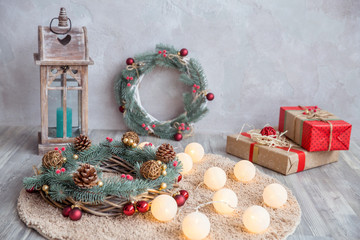 Decorative conifer wreath with cones, shiny Christmas tree toys