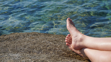 Foot with sea water in background