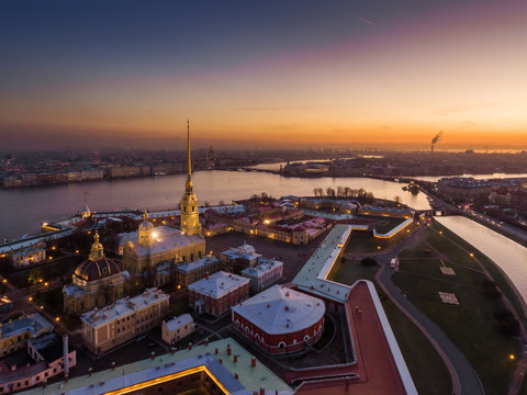 Russia, Saint-Petersburg, 02 November 2017: Aerial photo of Peter and Paul Fortress at sunset, cathedral, traffic, nightlights, illumination, clear weather, reflections, cityscape, landmark, Hermitage