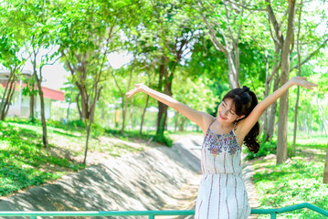 Naklejka premium A beautiful asian young girl on the bridge at forest with smile