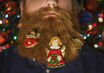 Portrait of a man with a decorated beard for the Christmas holiday. Christmas decoration.