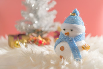 Happy snowman standing in blue winter christmas snow background. Merry christmas and happy new year greeting card with copy-space.
