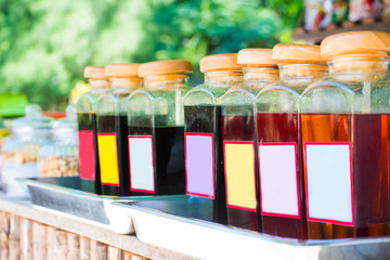 Colorful sweet syrup in glass bottles