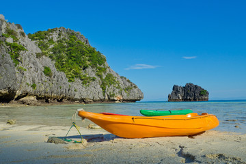 Fototapeta premium beach and sea with Kayak boat. beautiful beach and sea with mountain background. Clear sea. Summer time. Relax on holidays. Travel