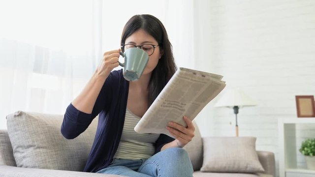 woman reading newspaper in the morning