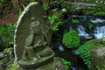Fototapeta premium 胴腹滝 湧き水を守る石仏 山形県遊佐町 Mountain spring water and stone Buddha / Yuza, Yamagata, Japan