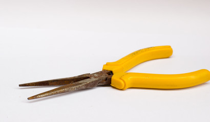 the pliers on the wooden floor with copy space on white background isolate