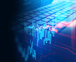 laptop keyboard on technology financial graph background.