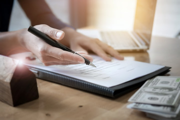 agreement paper,estate agent gives pen and documents agreement with customer to sign contract for ....