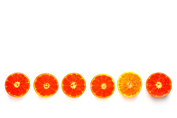 a row of halves of manadarine on a white background isolate.Look