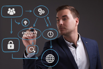 The concept of business, technology, the Internet and the network. Young businessman showing inscription: Employee benefits