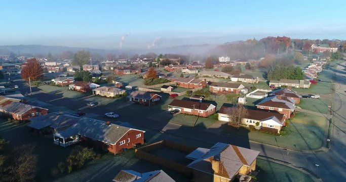 A forward rising aerial establishing shot of a typical Western Pennsylvania residential neighborhood on a frosty late-Autumn morning. Pittsburgh suburbs. Shot at 60fps.  	