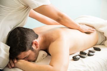 Obraz na płótnie Canvas Hot stone massage at a spa