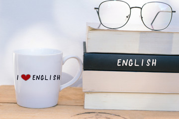 A cup of coffee and English textbooks - learning English language concept