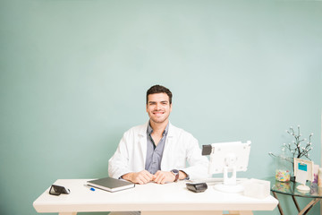 Hispanic male therapist in a front desk