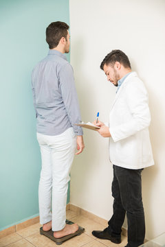 Nutritionist weighing a patient