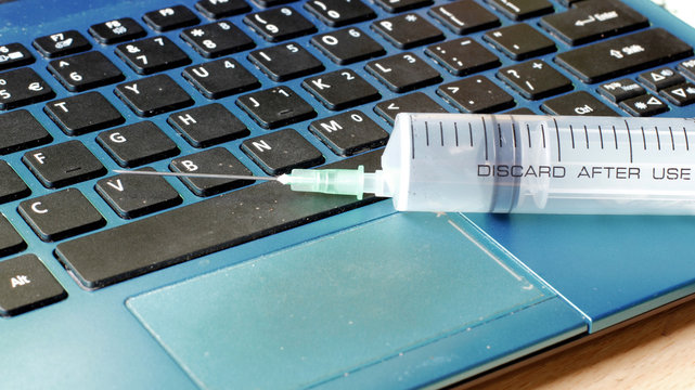 Injection into a laptop, internet security and antivirus protection concept
