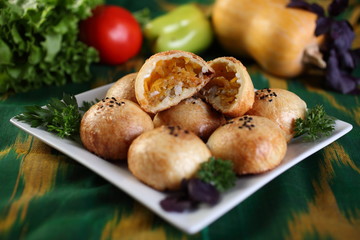 Samsa with pumpkin.Surface grease soaked seeds of black cumin and bake in the tandoor.Uzbek cuisine.