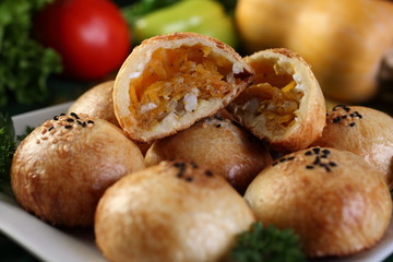 Samsa with pumpkin.Surface grease soaked seeds of black cumin and bake in the tandoor.Uzbek cuisine.Selective focus