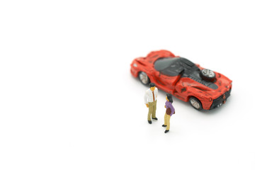 Miniature 2 people stand  to negotiate a settlement in a car crash insurance concept. with copy space.