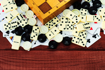 Various board games chess board, playing cards, dominoes. Hobby. Metaphor for games and gambling.
