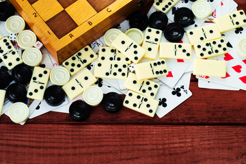 Various board games chess board, playing cards, dominoes. Hobby. Metaphor for games and gambling.