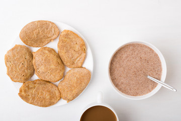 Fritters, coffee and flax-seed porridge on white