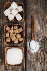 Three bowls with sugar and a wooden spoon