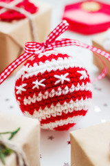 Christmas and New Year  background with presents, decorations and crocheted handmade decorative ball.